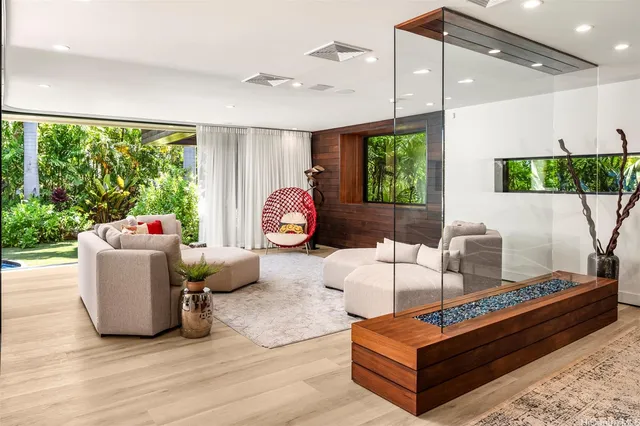 a living room with furniture a window and a flat screen tv