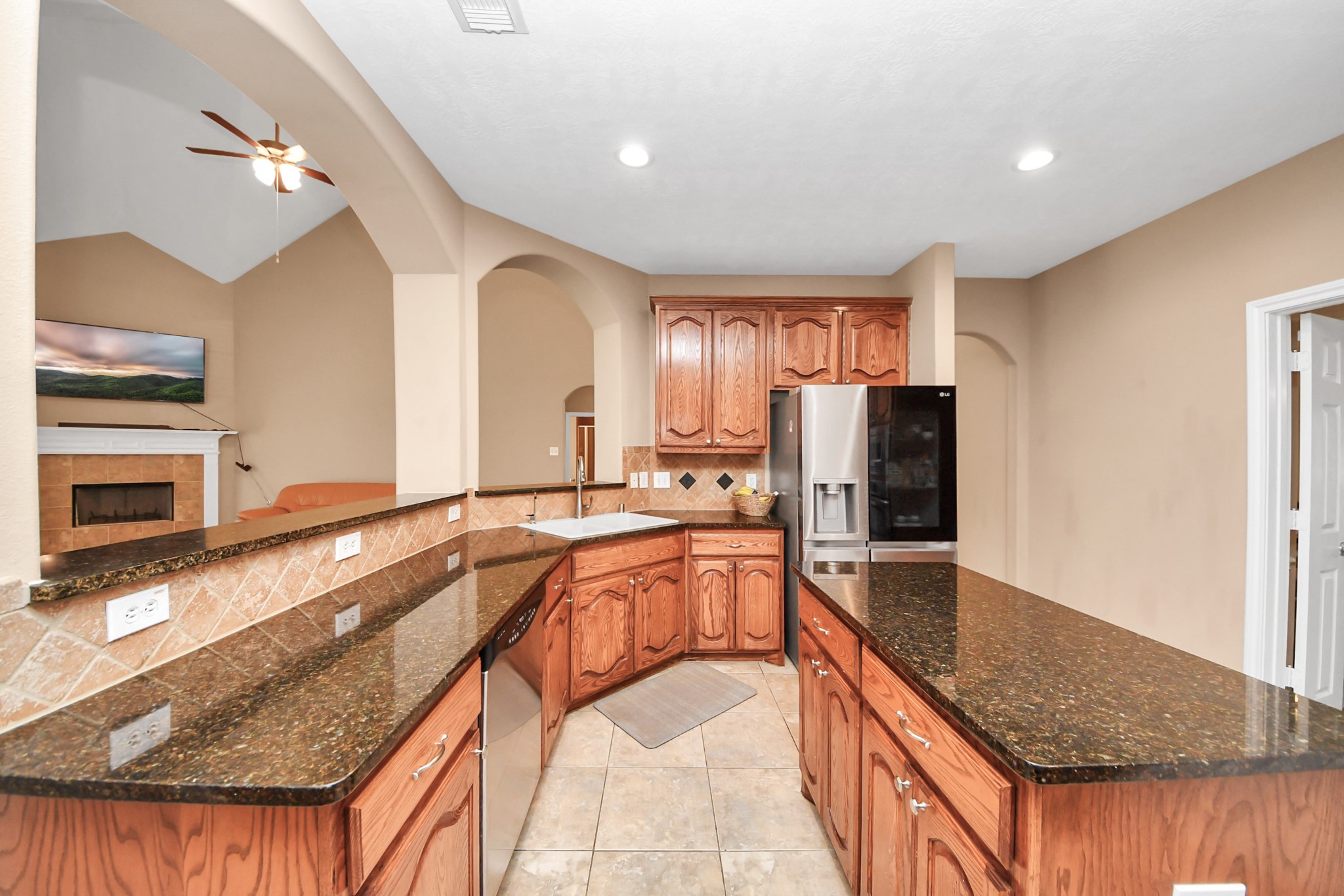 706 River Delta Lane Rosenberg, TX 77469 - Photo 12 of 50 a large kitchen with stainless steel appliances granite countertop a sink refrigerator and microwave