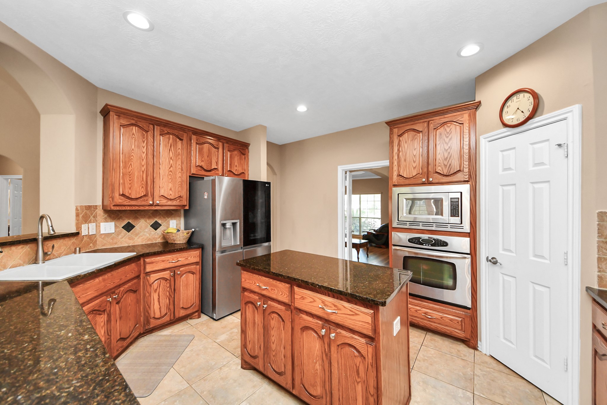 706 River Delta Lane Rosenberg, TX 77469 - Photo 13 of 50 a kitchen with stainless steel appliances granite countertop a refrigerator stove top oven sink and cabinets