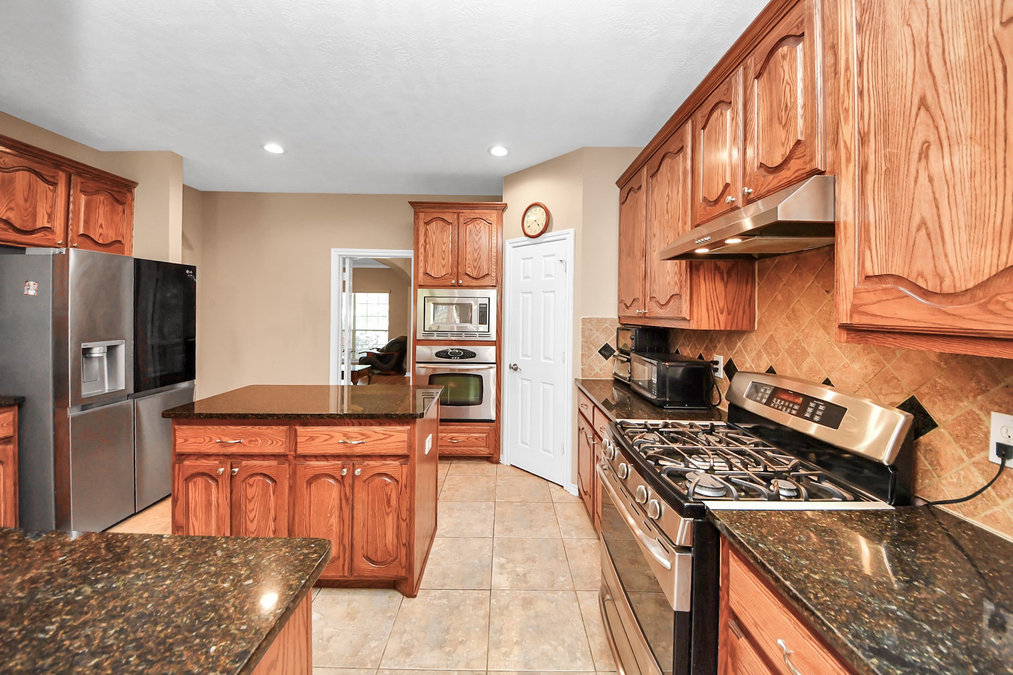 706 River Delta Lane Rosenberg, TX 77469 - Photo 16 of 50 a kitchen with stainless steel appliances granite countertop a stove top oven a refrigerator a sink and dishwasher