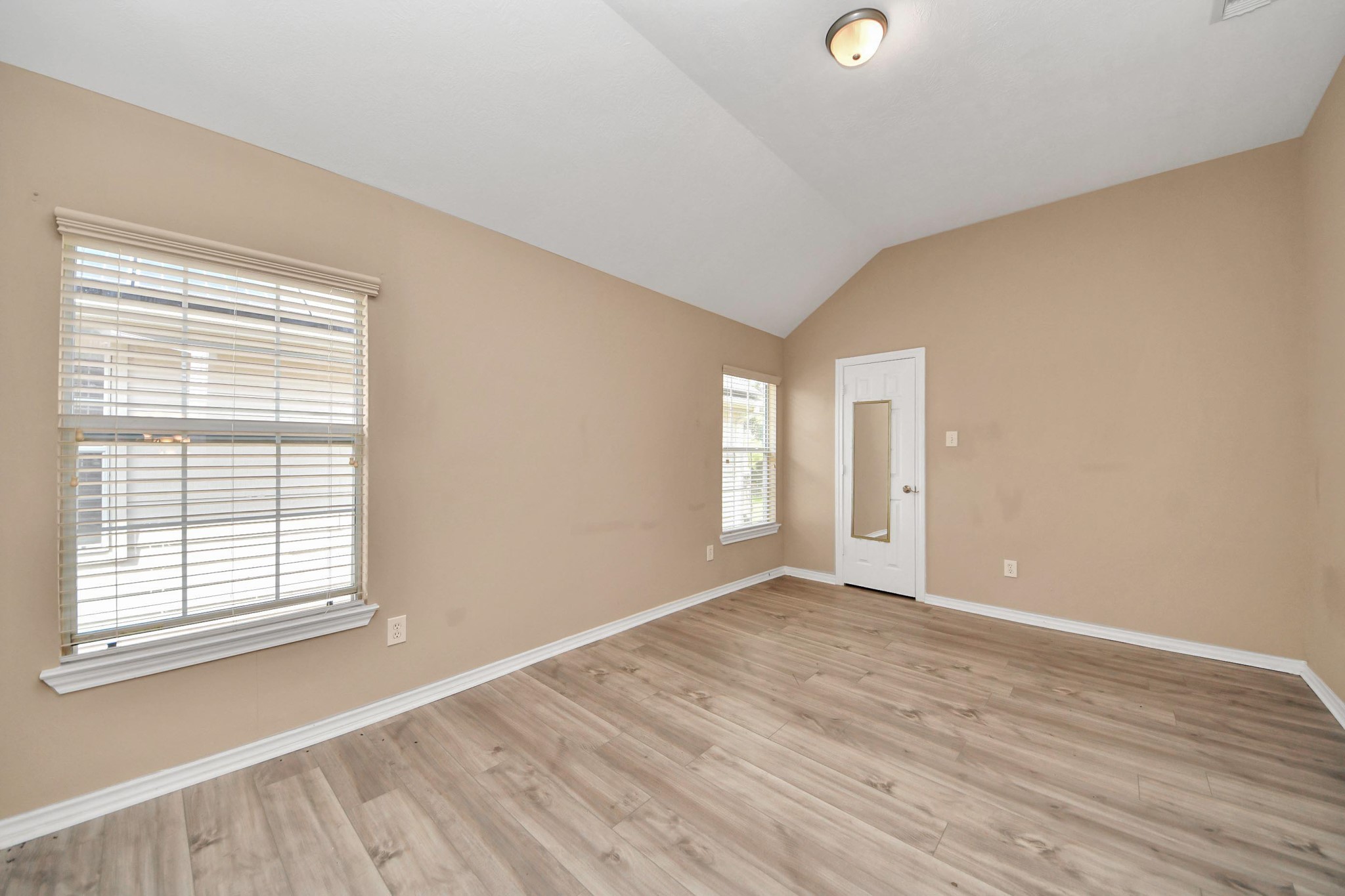 706 River Delta Lane Rosenberg, TX 77469 - Photo 33 of 50 a view of an empty room with wooden floor and a window