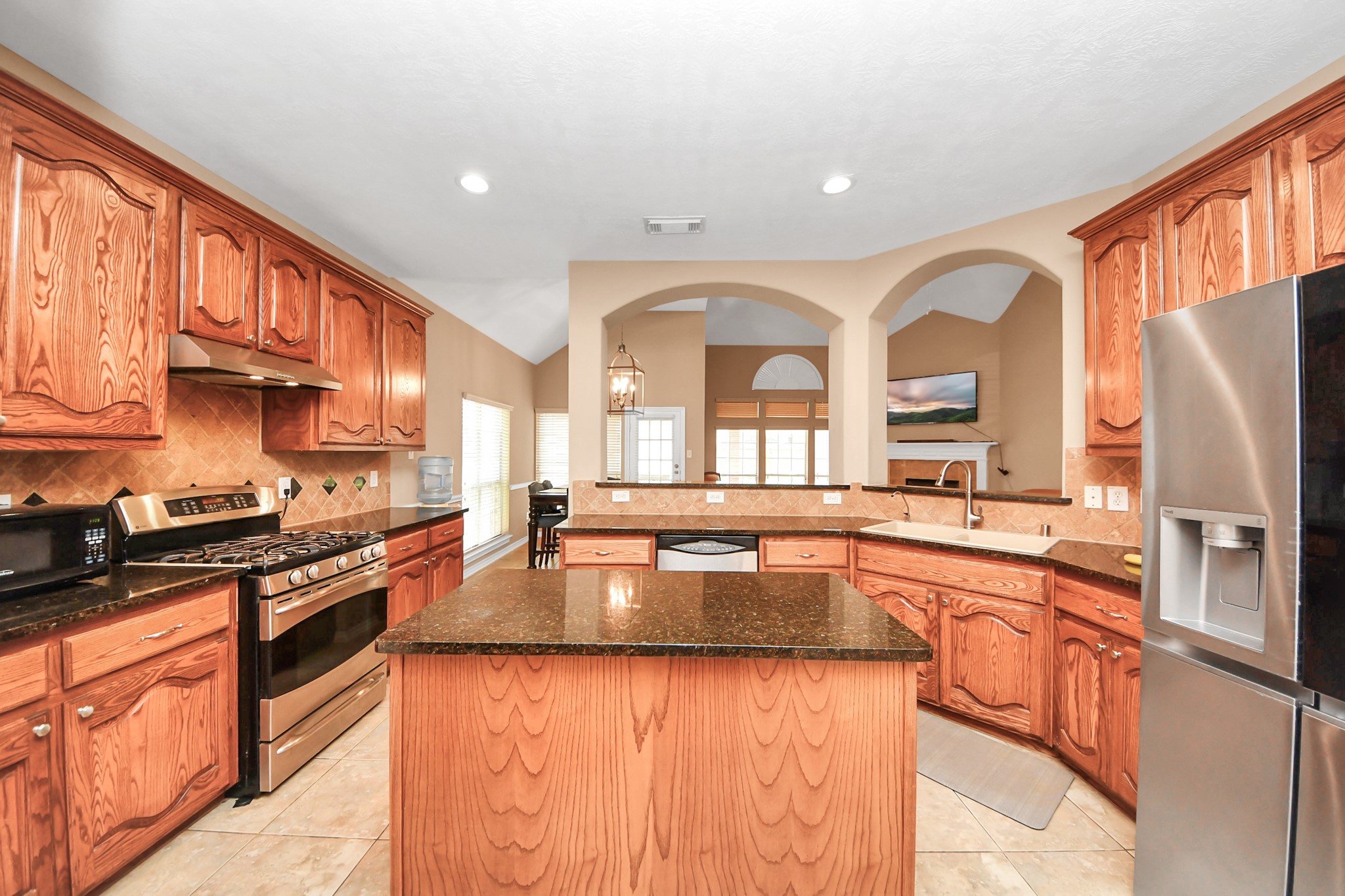 706 River Delta Lane Rosenberg, TX 77469 - Photo 9 of 50 a large kitchen with stainless steel appliances granite countertop a lot of counter space and a sink
