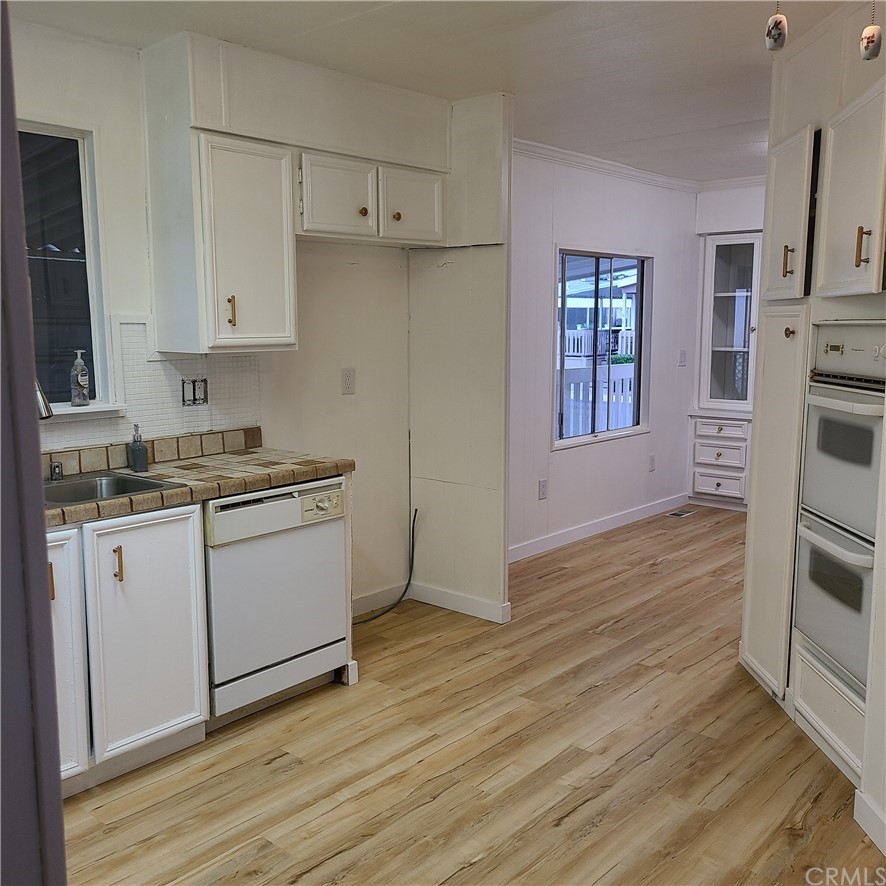 3700 Buchanan, Unit 98 Corona, CA 92503 - Photo 11 of 24 a kitchen with granite countertop white cabinets and white appliances