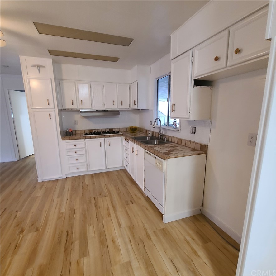 3700 Buchanan, Unit 98 Corona, CA 92503 - Photo 12 of 24 a kitchen with granite countertop a stove a sink and a refrigerator