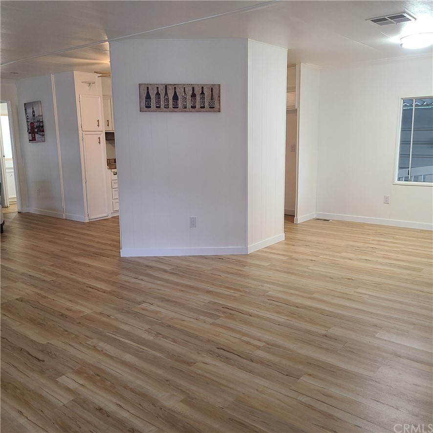 3700 Buchanan, Unit 98 Corona, CA 92503 - Photo 7 of 24 a view of an empty room with wooden floor