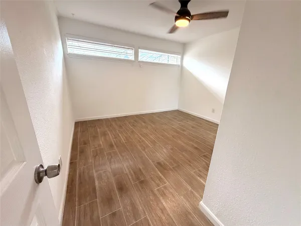 a view of a room with wooden floor