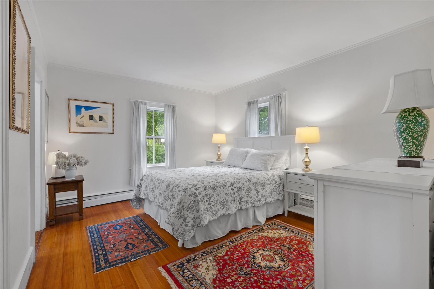21 Quaker Road East Sandwich, MA 02537 - Photo 20 of 43 a bedroom with a bed and a lamp on dresser