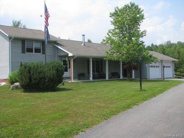 a front view of a house with a garden and yard