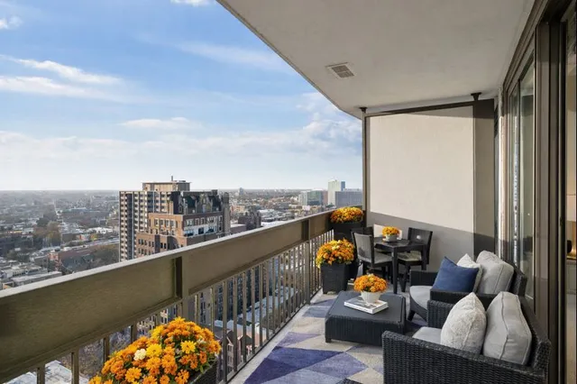 a balcony with furniture and city view