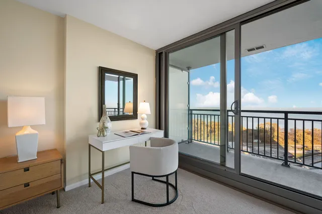 a room with a table chairs and a mirror