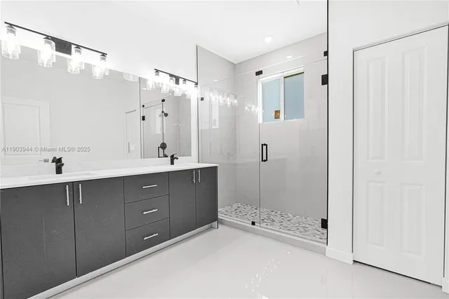 a view of kitchen with stainless steel appliances kitchen island microwave and refrigerator