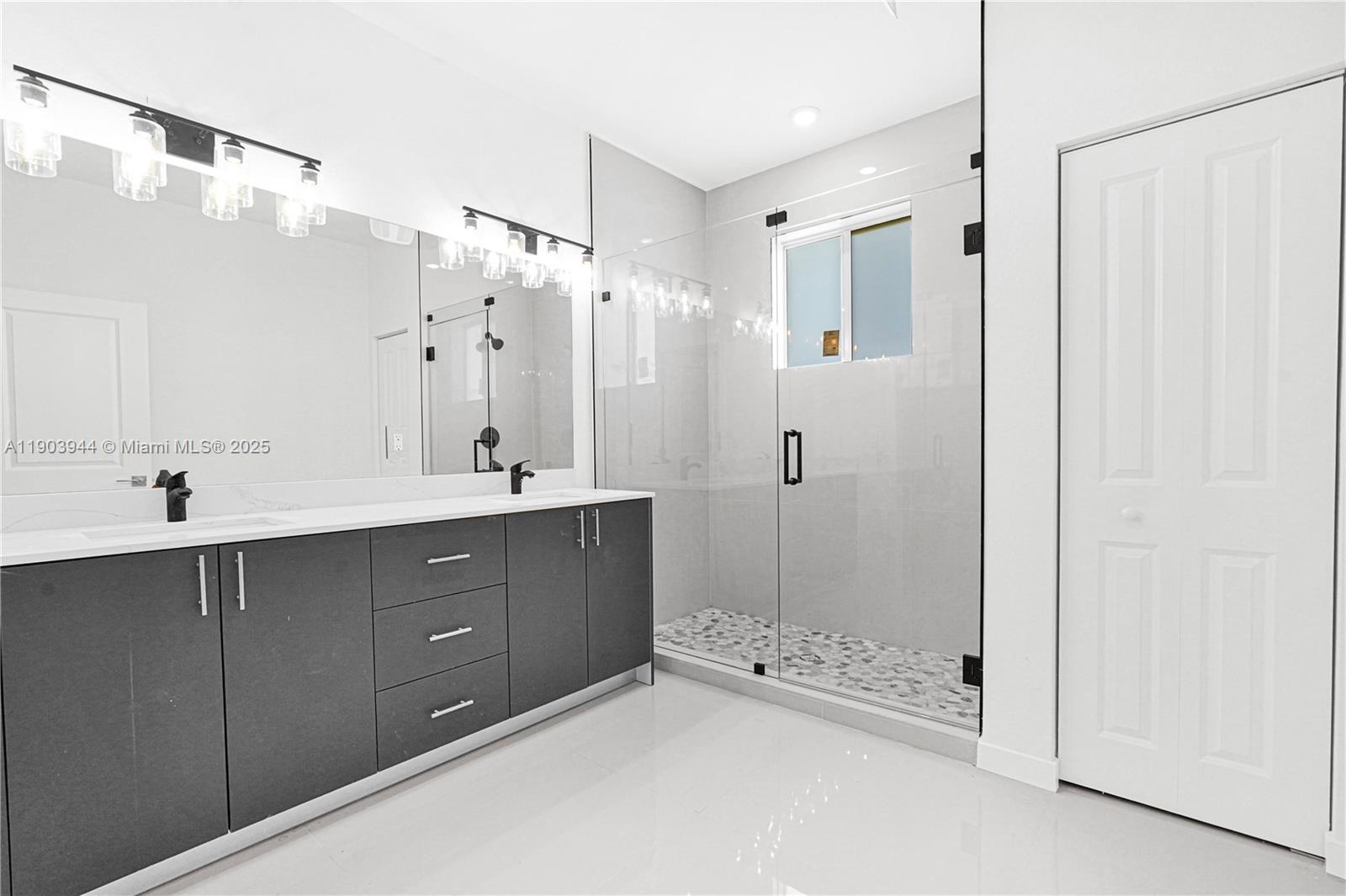 22555 Southwest 125th Avenue, Unit 13A Miami, FL 33170 - Photo 14 of 100 a bathroom with a double vanity sink a large mirror and shower