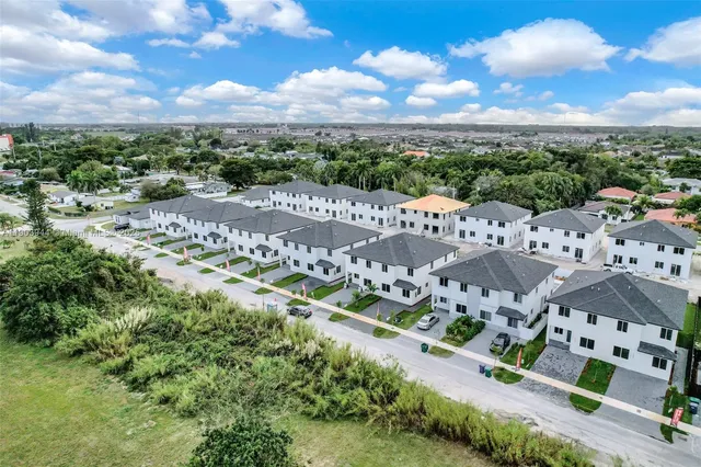 a kitchen with stainless steel appliances a refrigerator stove a sink and a oven