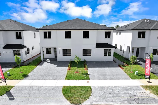 a bathroom with a sink vanity mirror and toilet