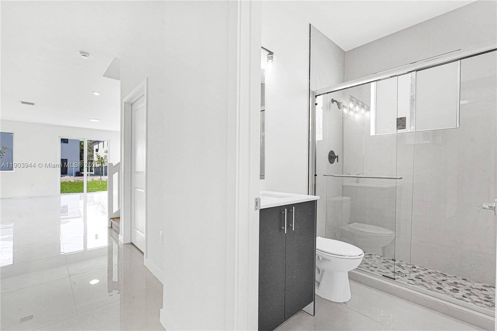 22555 Southwest 125th Avenue, Unit 13A Miami, FL 33170 - Photo 34 of 100 a bathroom with a toilet a sink and shower