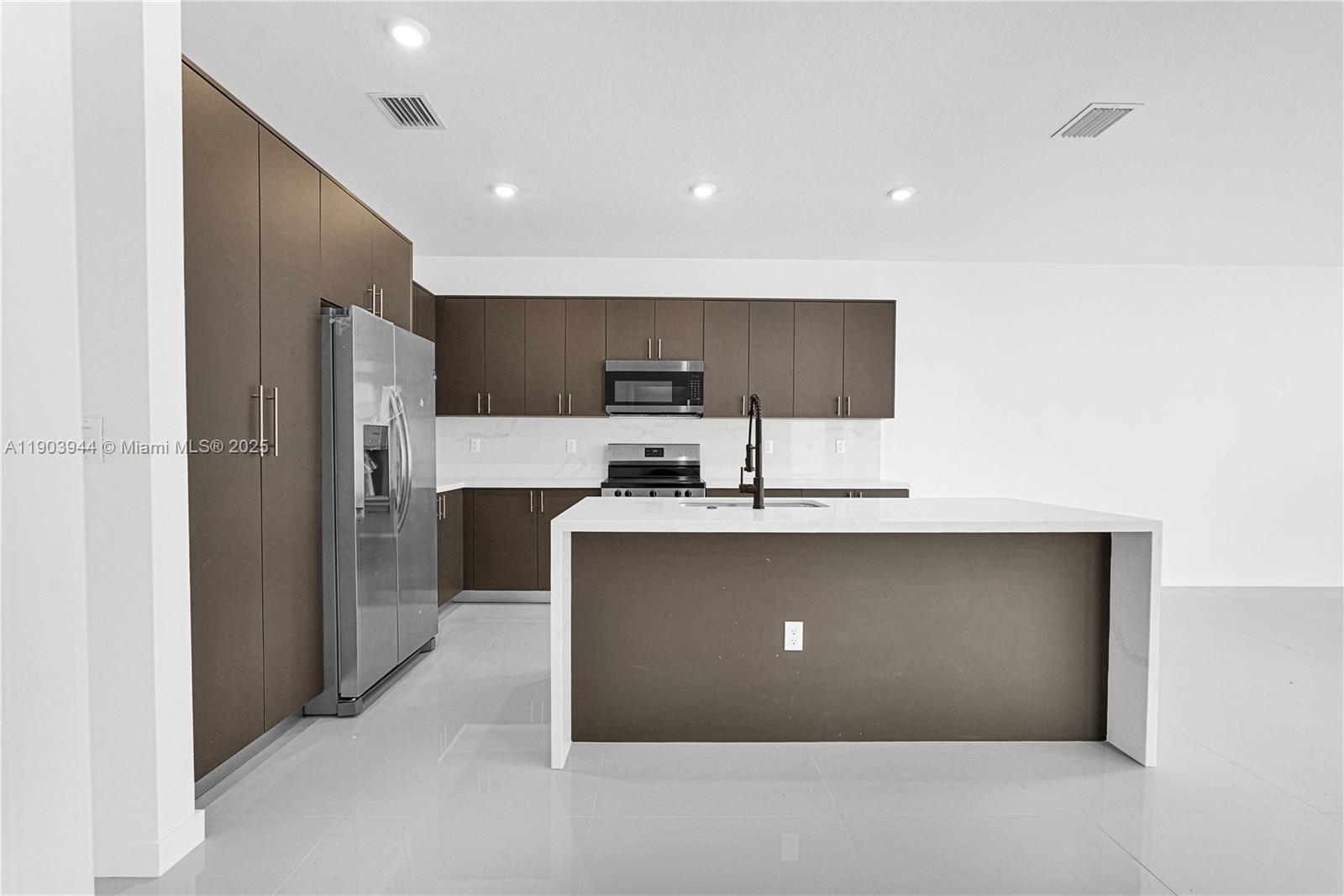 22555 Southwest 125th Avenue, Unit 13A Miami, FL 33170 - Photo 36 of 100 a view of kitchen with stainless steel appliances kitchen island microwave and refrigerator