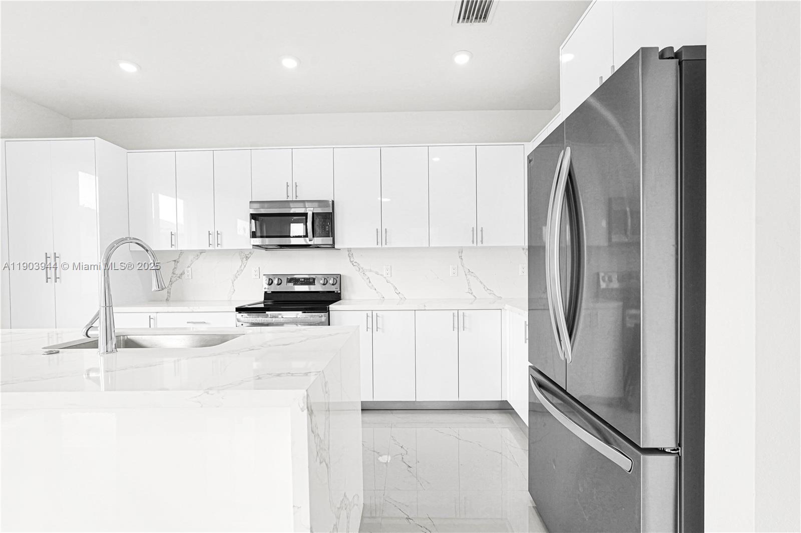 22555 Southwest 125th Avenue, Unit 13A Miami, FL 33170 - Photo 42 of 100 a kitchen with stainless steel appliances granite countertop a refrigerator a stove a sink and a microwave