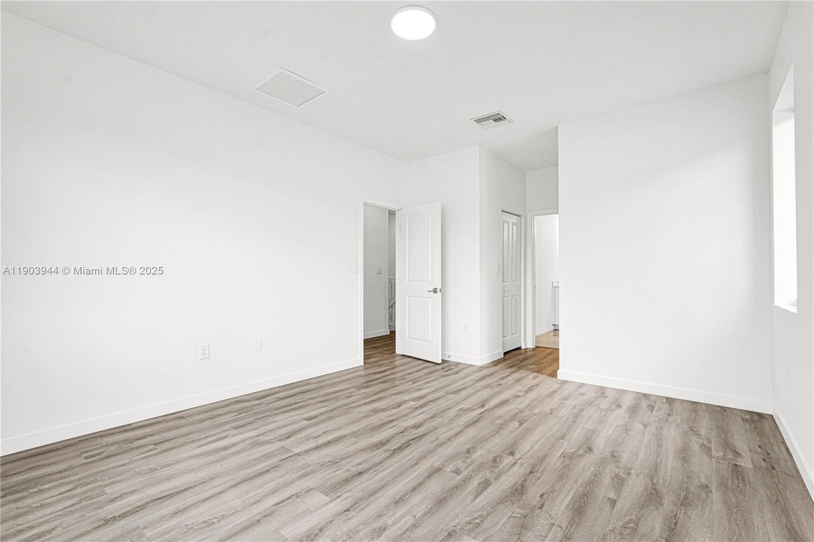 22555 Southwest 125th Avenue, Unit 13A Miami, FL 33170 - Photo 58 of 100 a view of an empty room with wooden floor