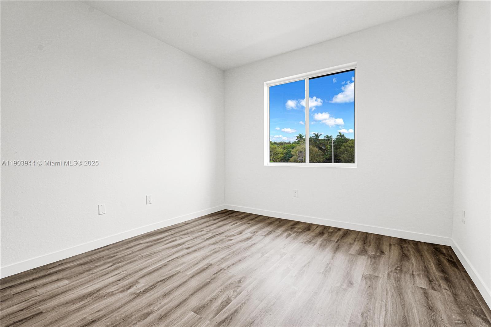 22555 Southwest 125th Avenue, Unit 13A Miami, FL 33170 - Photo 77 of 100 an empty room with wooden floor and windows