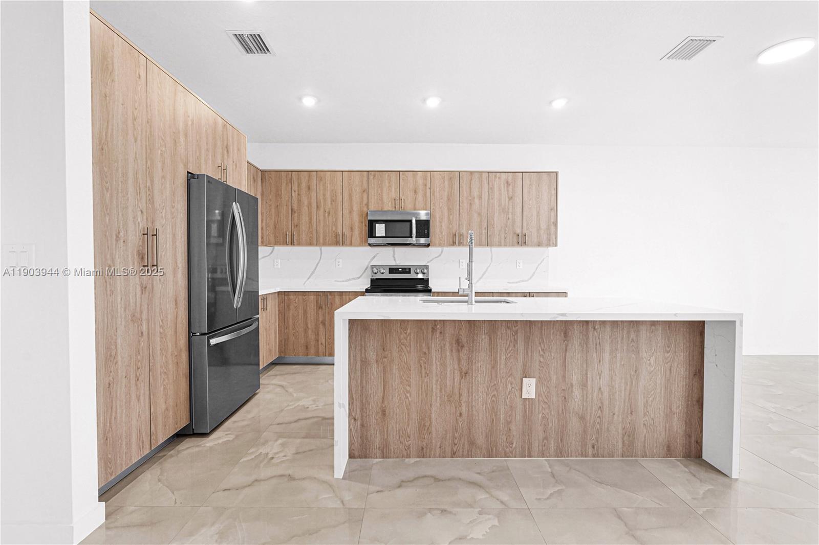 22555 Southwest 125th Avenue, Unit 13A Miami, FL 33170 - Photo 86 of 100 a kitchen with stainless steel appliances granite countertop a refrigerator and a stove