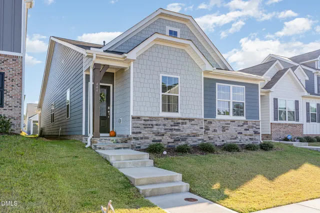 a front view of a house with a garden