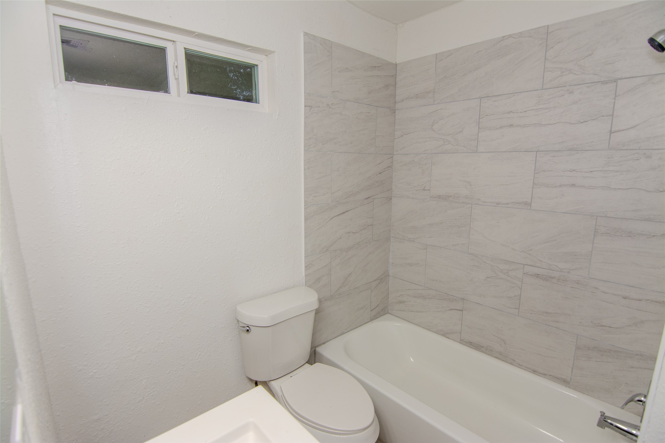 10815 Ritow Street Houston, TX 77089 - Photo 11 of 12 a white toilet sitting next to a bath tub