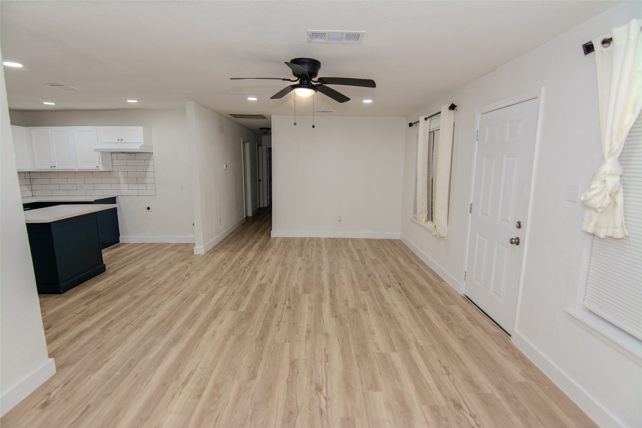 10815 Ritow Street Houston, TX 77089 - Photo 2 of 12 a view of a room with wooden floor and a ceiling fan
