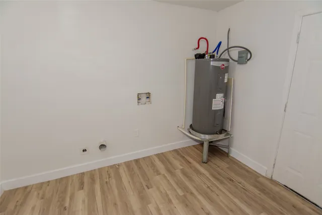 a view of a room with wooden floor
