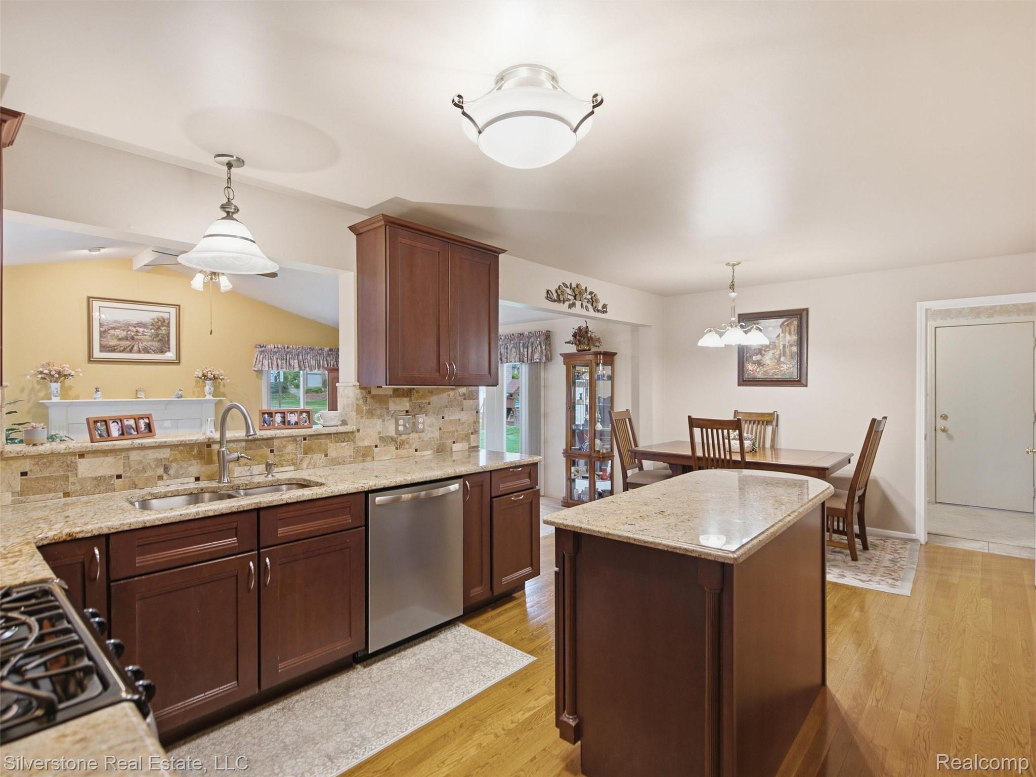 6577 Edith Court Troy, MI 48085 - Photo 24 of 61 Kitchen featuring wood-finish flooring, recessed lighting, and an island with a stone-finish countertop