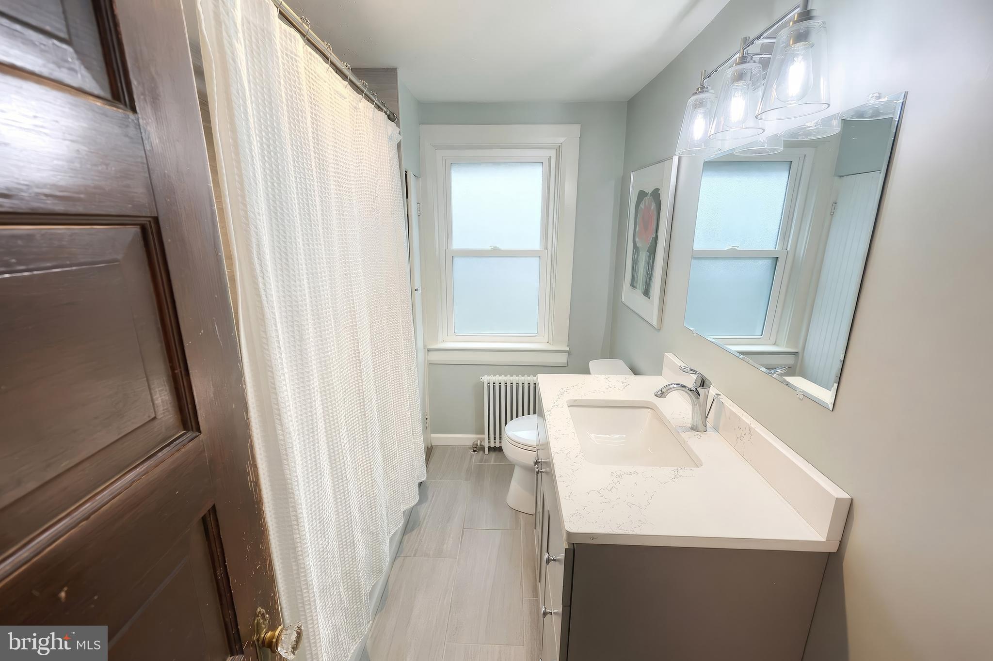 24 Park Street Jacobus, PA 17407 - Photo 18 of 40 a bathroom with a sink a mirror and a shower