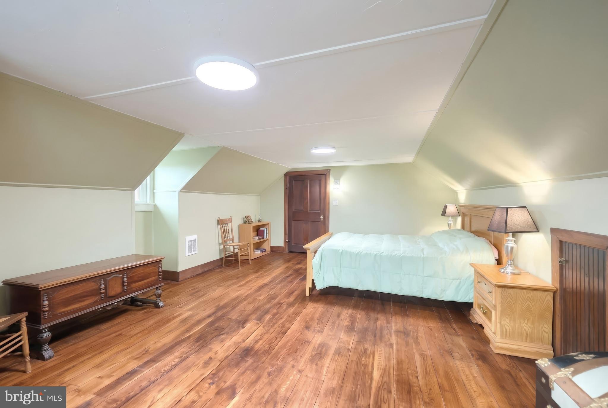 24 Park Street Jacobus, PA 17407 - Photo 27 of 40 a spacious bedroom with a bed and a dresser in it