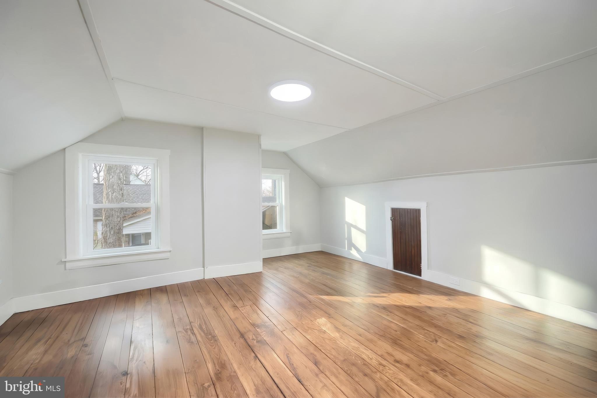 24 Park Street Jacobus, PA 17407 - Photo 29 of 40 an empty room with wooden floor and windows