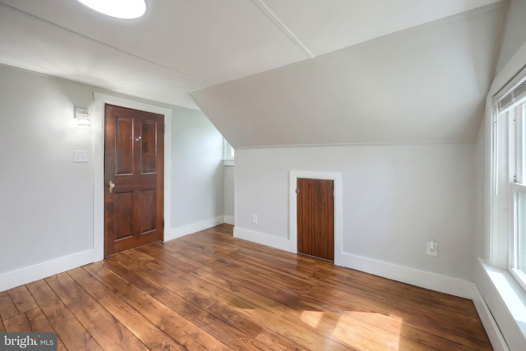 24 Park Street Jacobus, PA 17407 - Photo 30 of 40 a view of an empty room with wooden floor & window