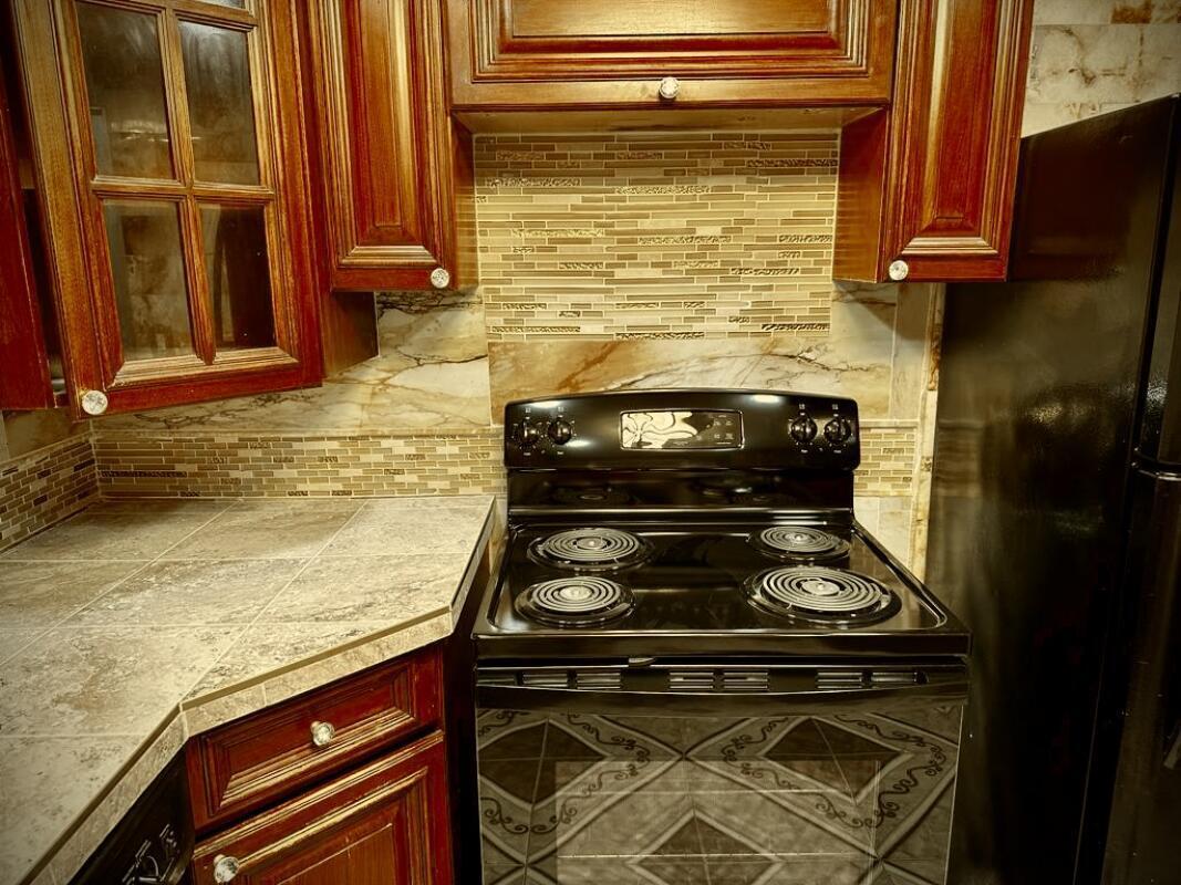 610 Northwest 13th Street, Unit 23 Boca Raton, FL 33486 - Photo 15 of 28 a stove top oven sitting inside of a kitchen