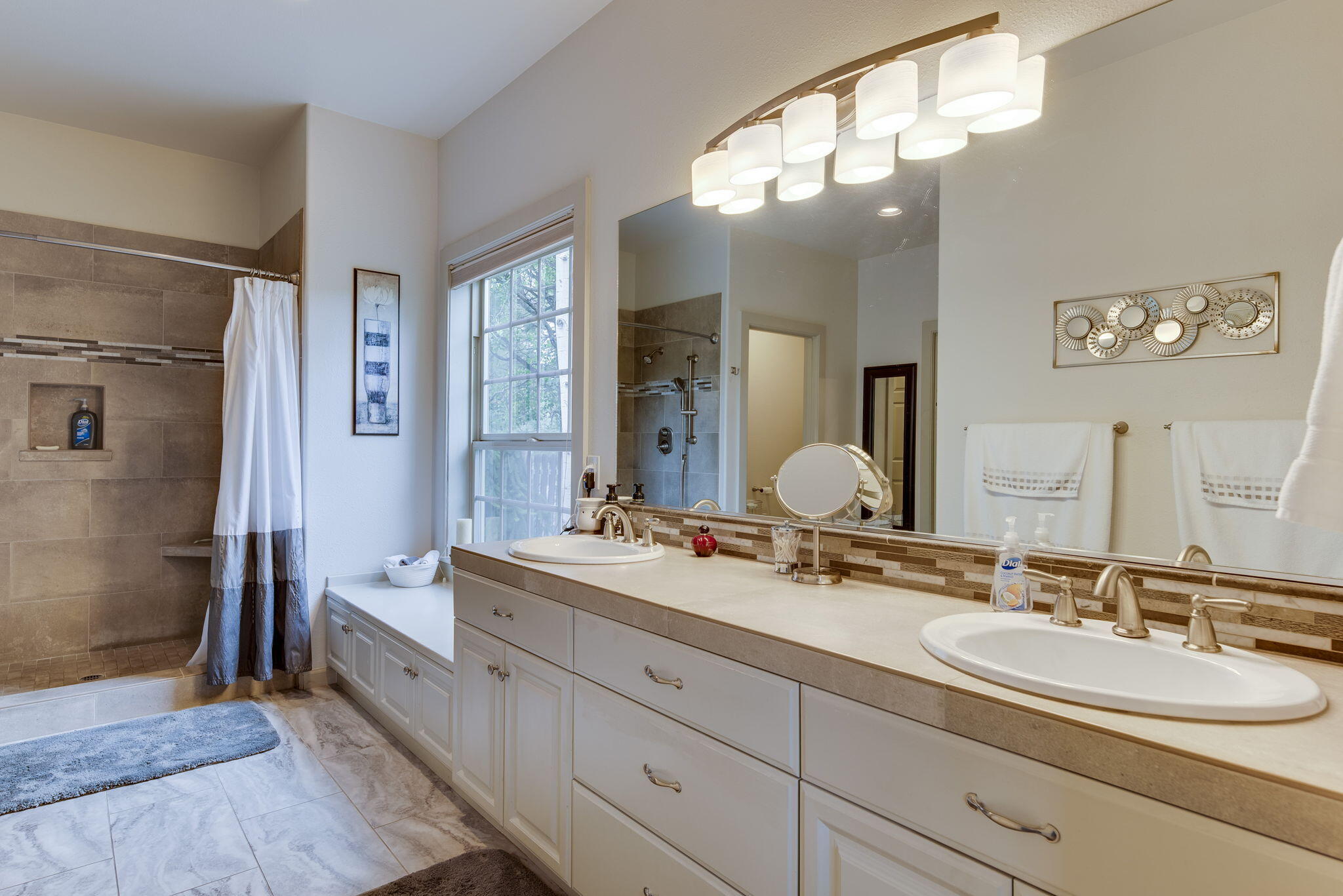 61538 Southeast Hill Ridge Road Bend, OR 97702 - Photo 31 of 59 a bathroom with double vanity sinks and a mirror
