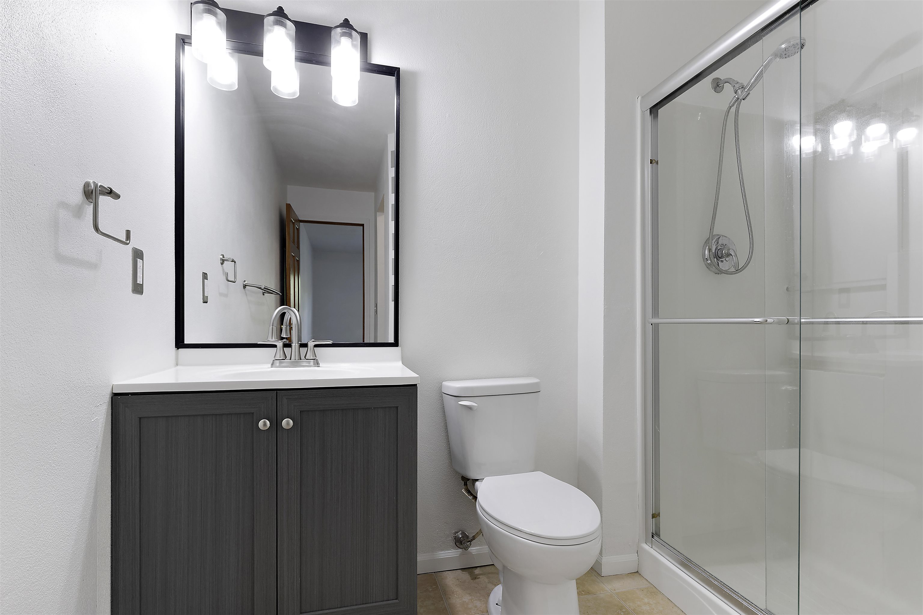 10050 Skipperling Road Roscoe, IL 61073 - Photo 12 of 15 a bathroom with a granite countertop sink toilet and shower
