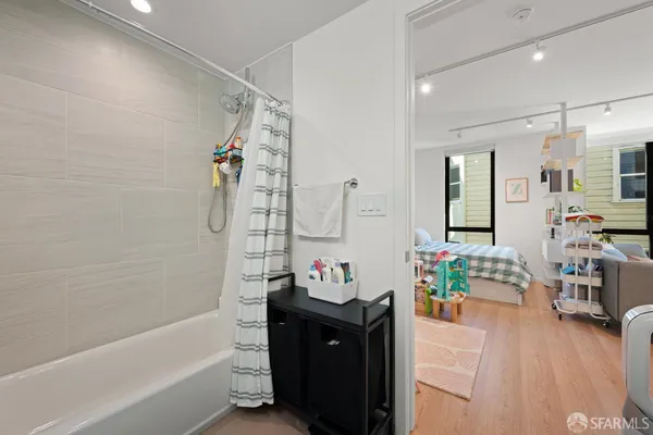 a bathroom with a tub sink and mirror