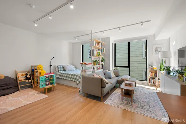a living room with furniture and a wooden floor
