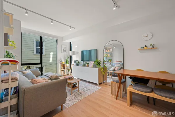 a living room with furniture and wooden floor