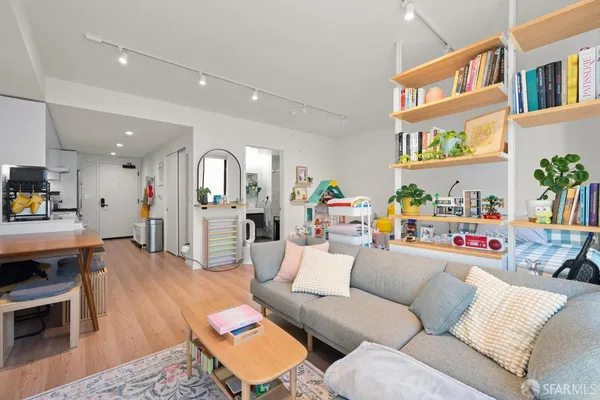 a living room with furniture and a book shelf
