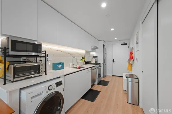 a kitchen with stainless steel appliances kitchen island granite countertop a sink and stove top oven