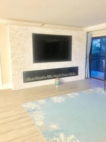 a living room with a flat screen tv and a fireplace