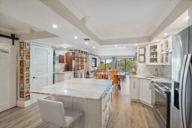 a view of a kitchen with cabinets and wooden floor