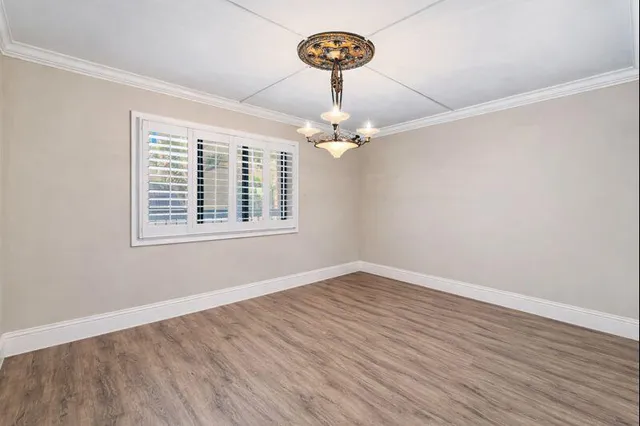a view of a room with a window and wooden floor