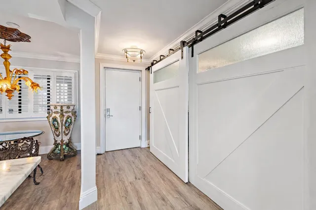 a view of a hallway with a hardwood floor and a hallway