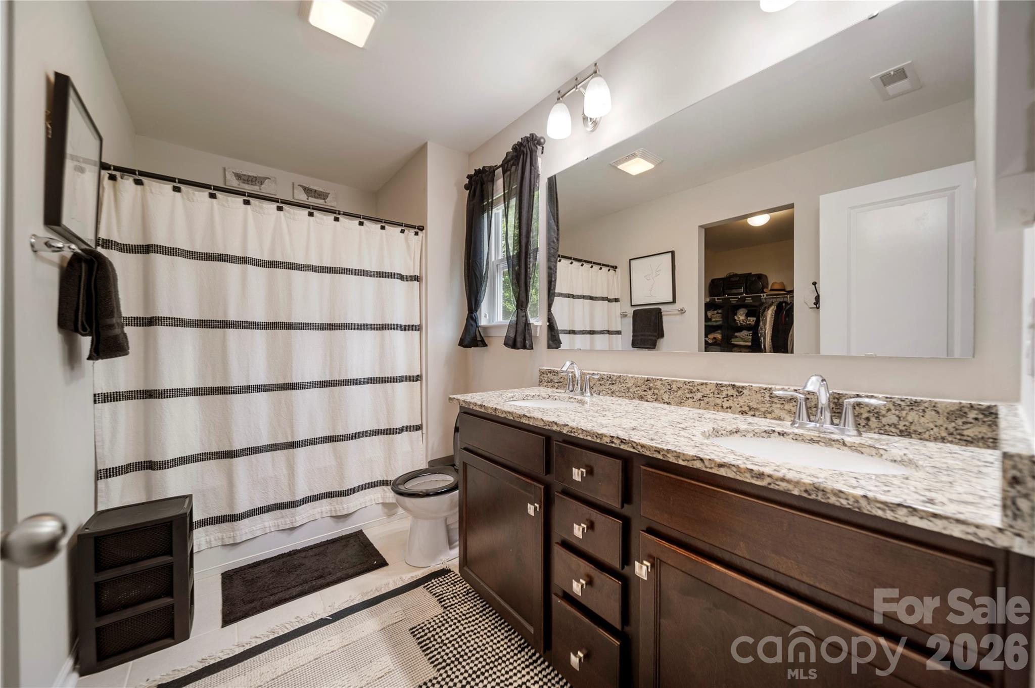 8122 Mossy Rock Road Waxhaw, NC 28173 - Photo 16 of 28 a bathroom with a sink and a mirror