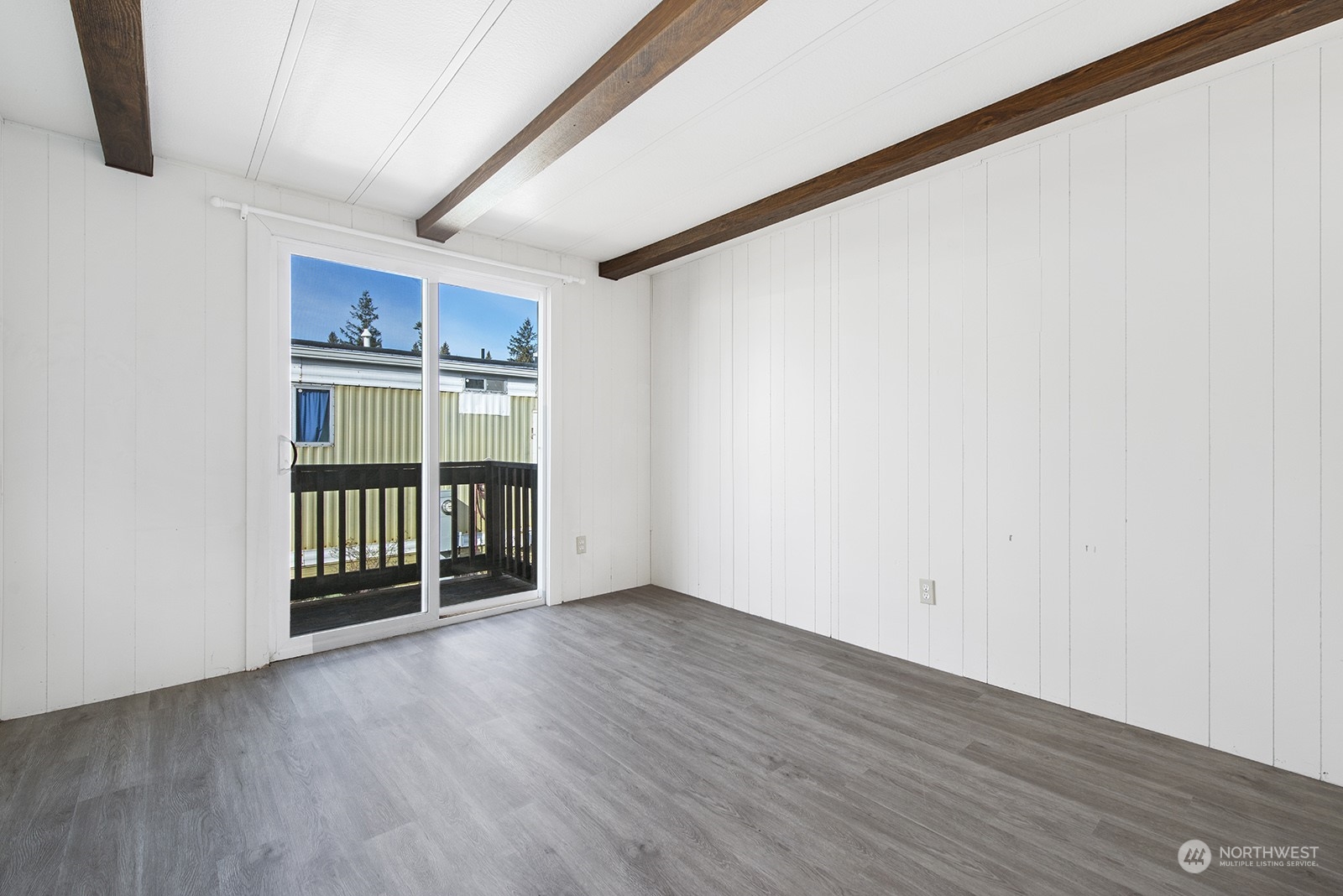 2302 R Street Southeast, Unit 140 Auburn, WA 98002 - Photo 14 of 18 a view of an empty room with wooden floor and a window