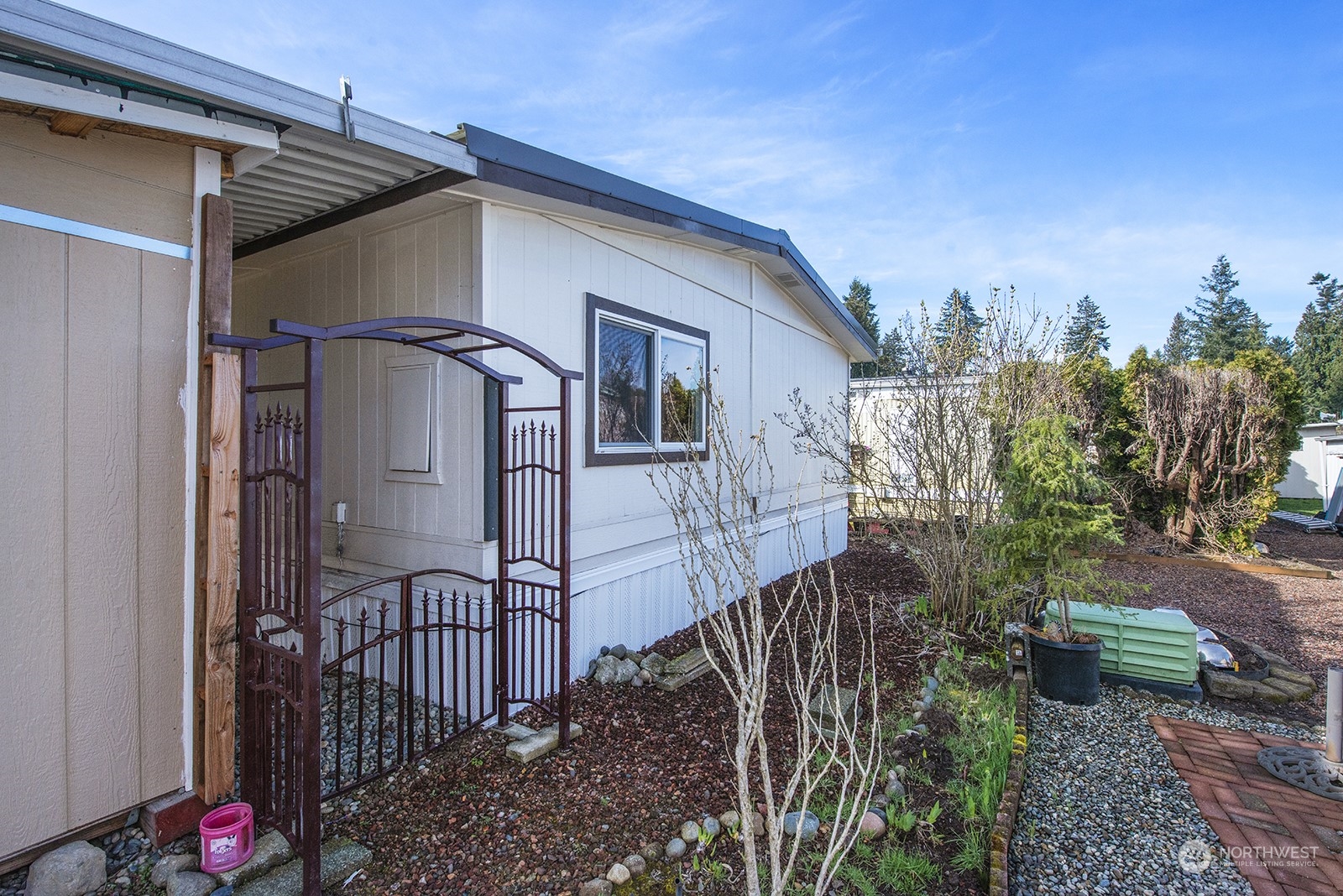 2302 R Street Southeast, Unit 140 Auburn, WA 98002 - Photo 16 of 18 a view of a house with wooden fence
