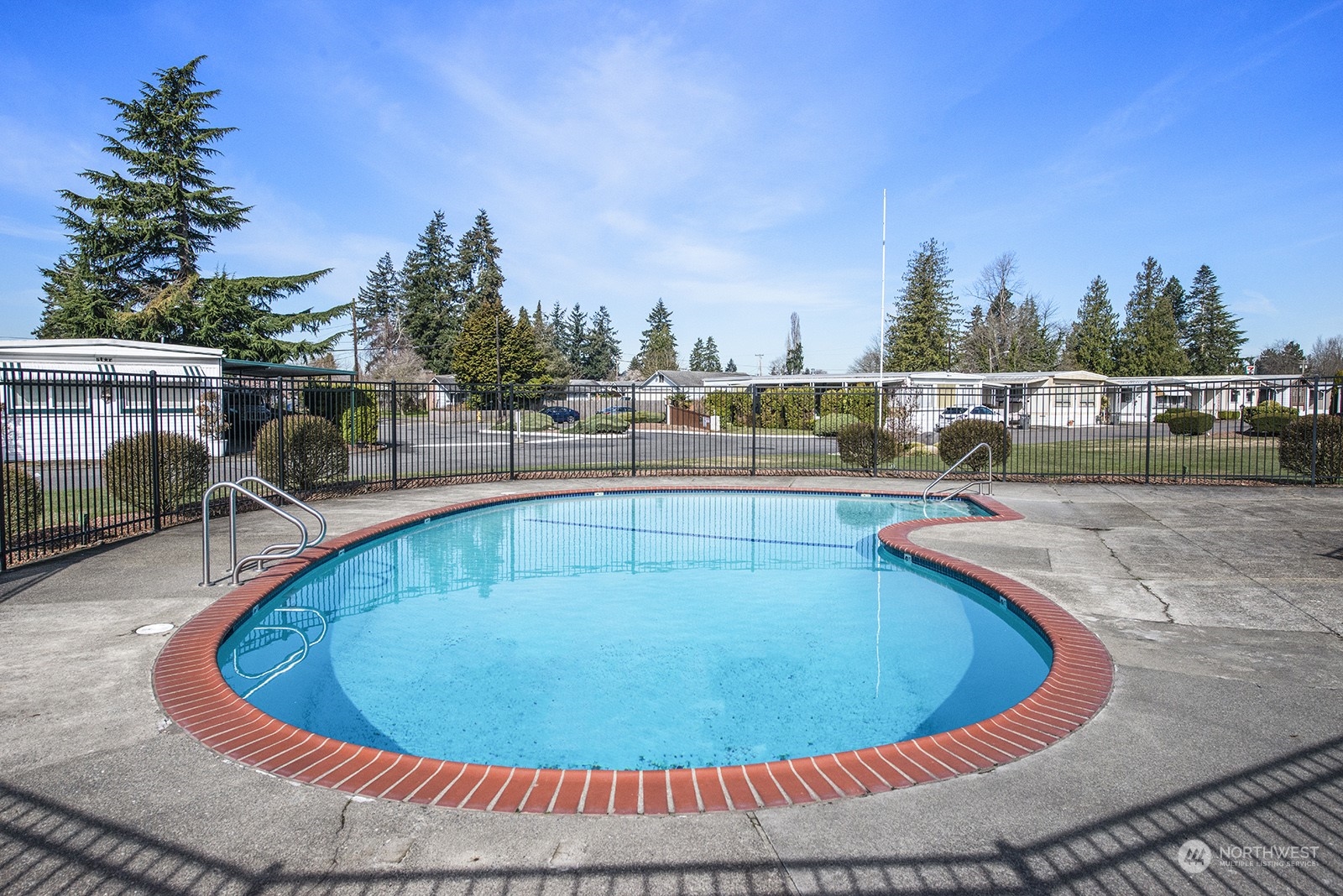 2302 R Street Southeast, Unit 140 Auburn, WA 98002 - Photo 18 of 18 a view of a swimming pool with chairs