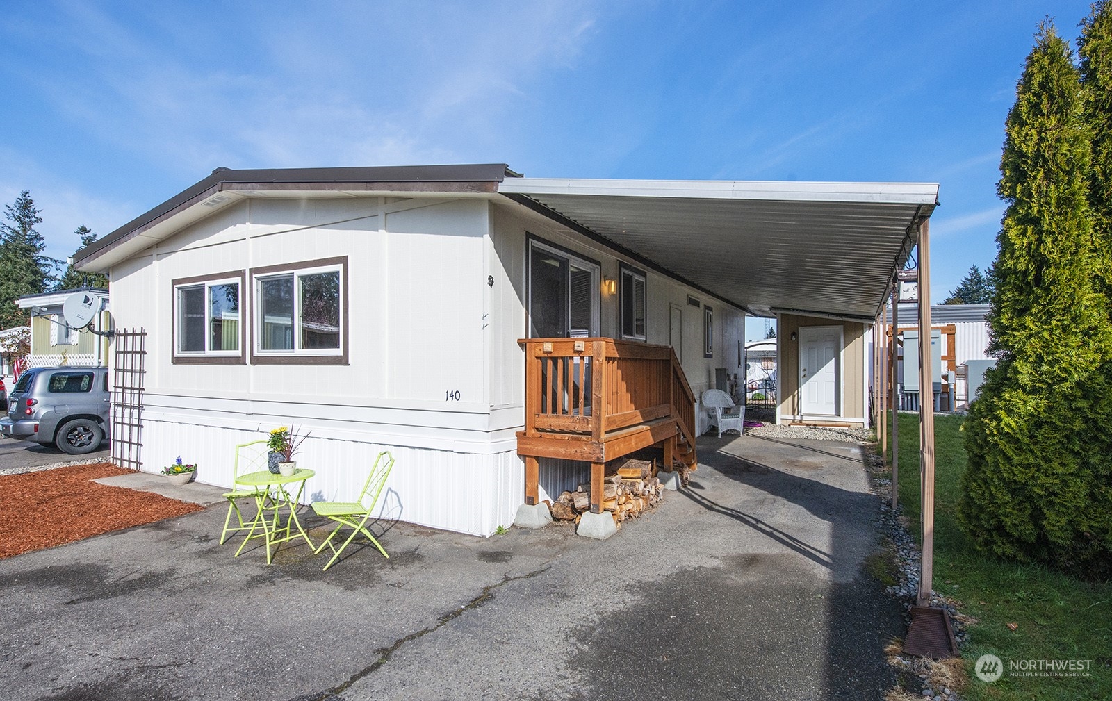 2302 R Street Southeast, Unit 140 Auburn, WA 98002 - Photo 2 of 18 a front view of a house with outdoor seating